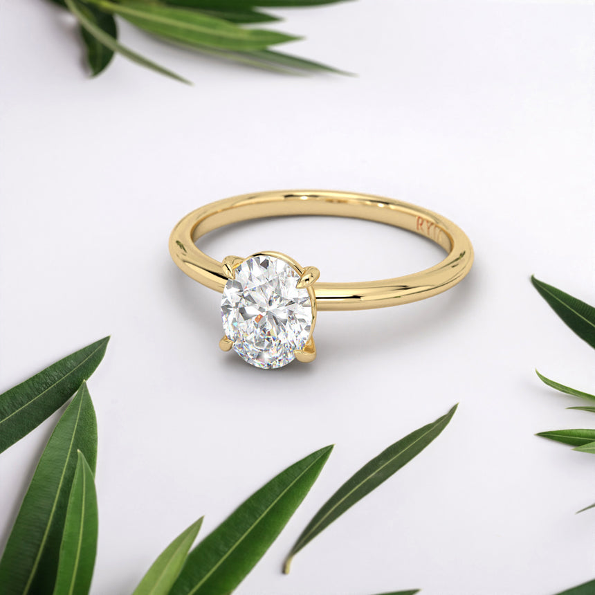 Here is an Engagement Ring with an Oval Lab-Diamond in Yellow Gold by RYIA Fine Jewelry